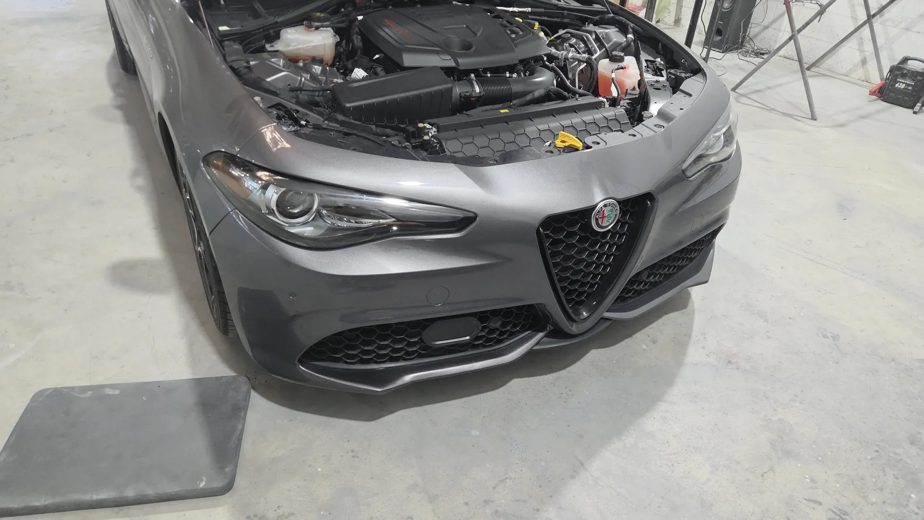 Gray Alfa Romeo with refinished front bumper installed