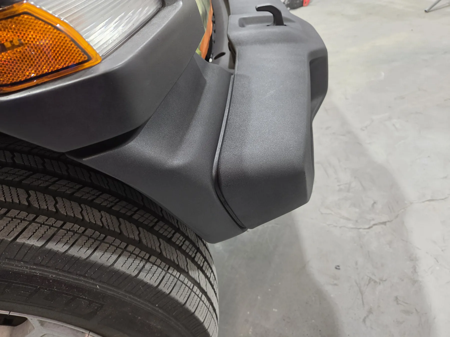 Black textured Jeep rear bumper after surface restoration